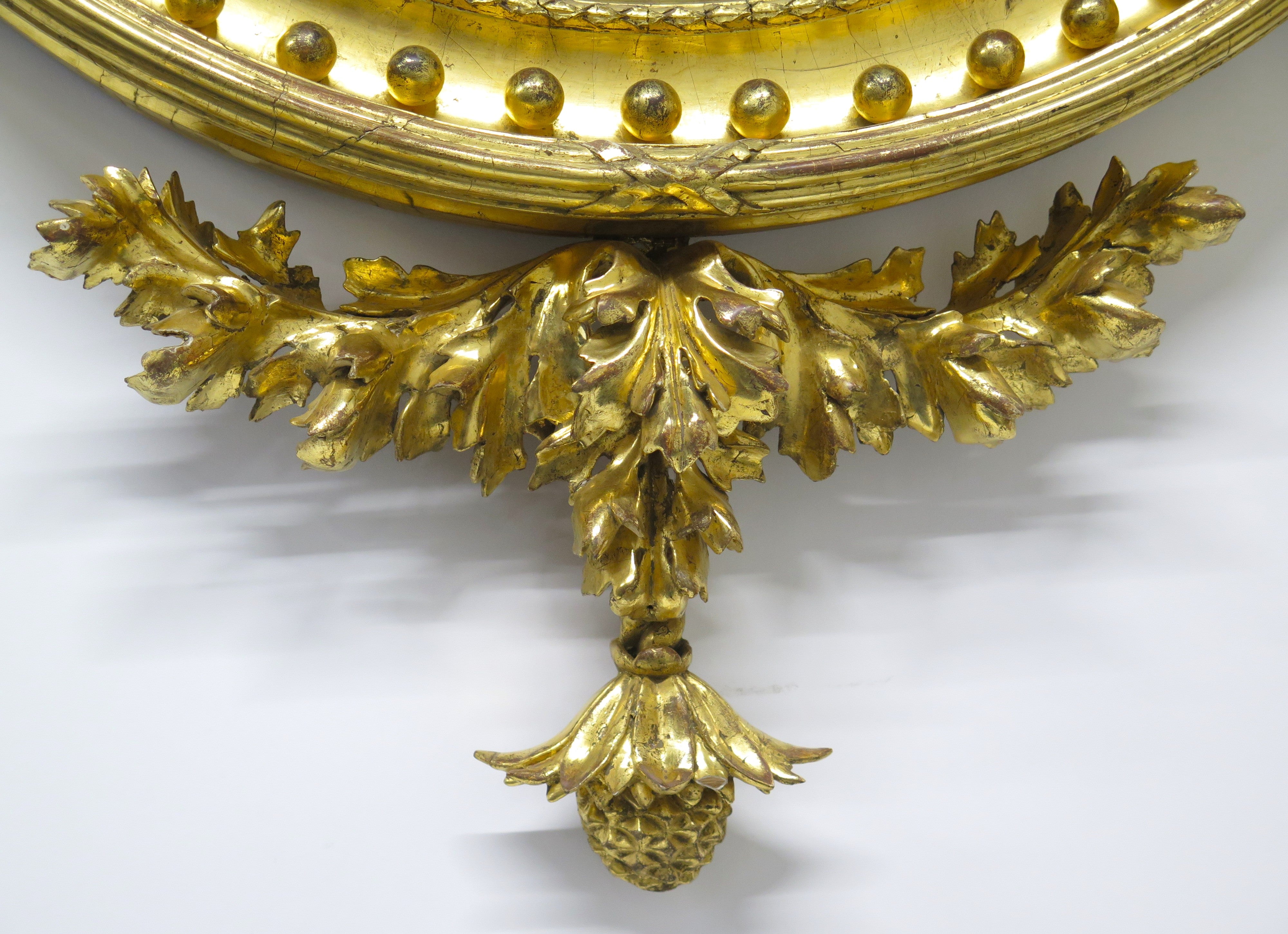 A Superb Early Regency Ebonised and Giltwood Convex Mirror