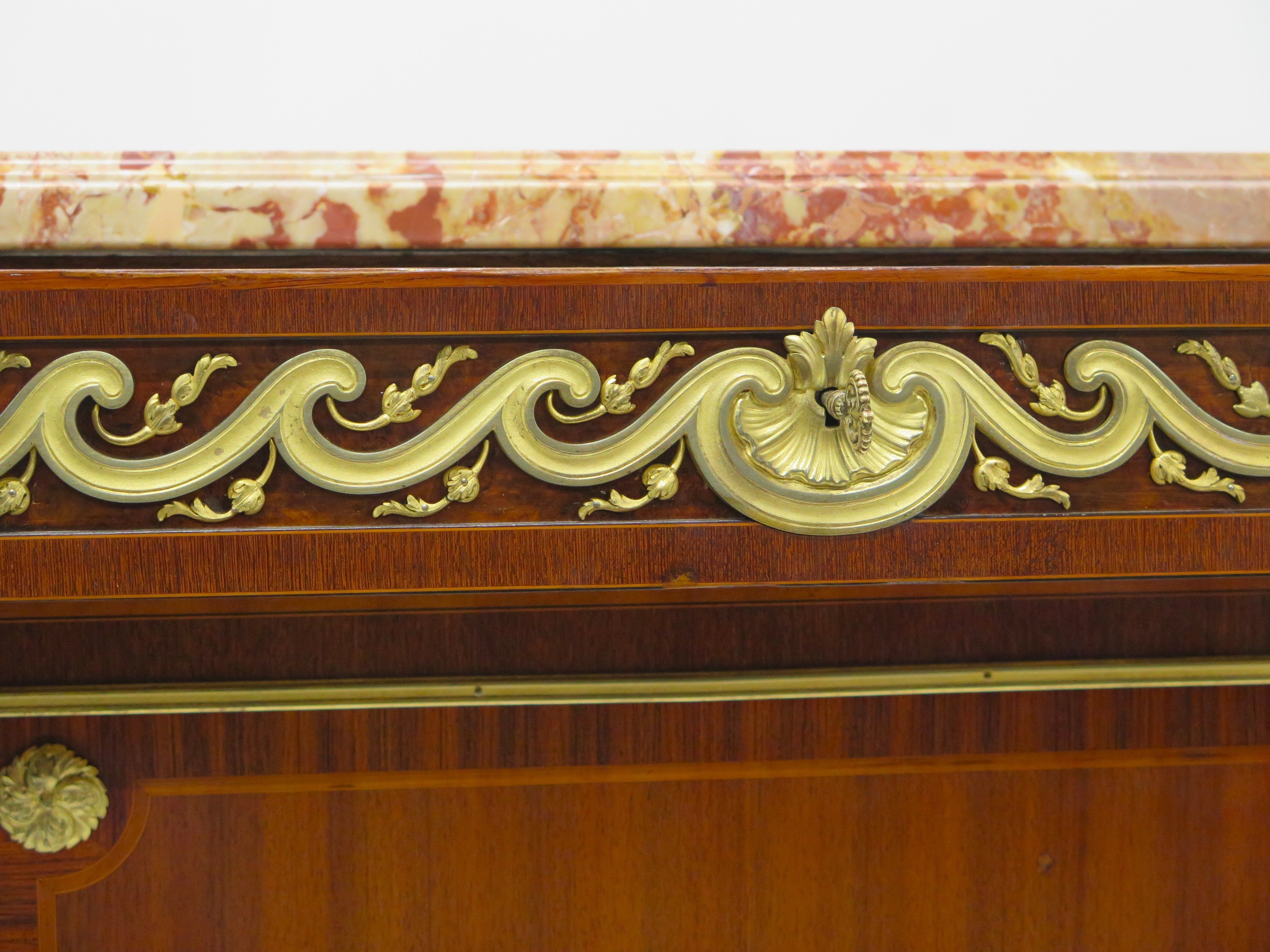 A French Ormolu-mounted Amaranth, Kingwood, Bois Satine, and Burr-amboyna Commode