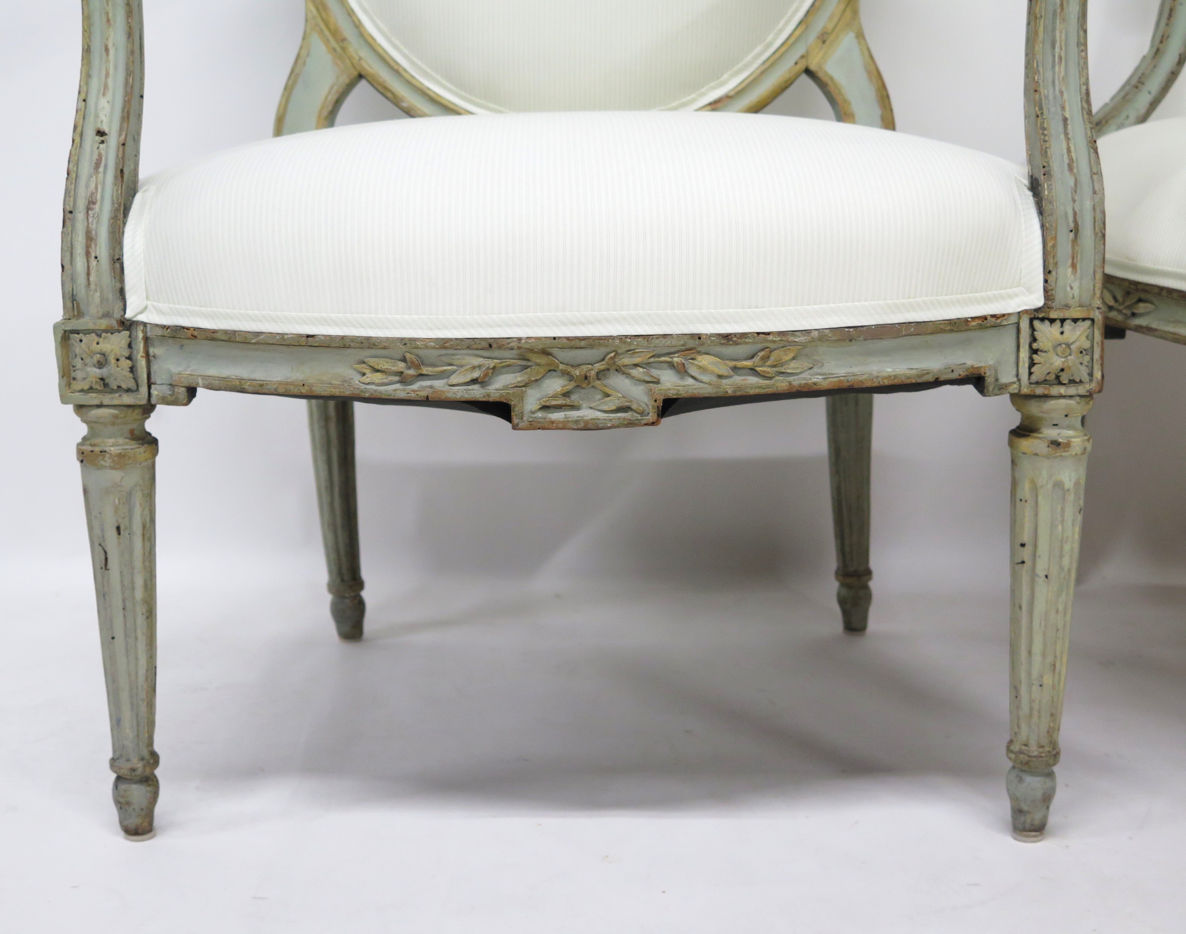 A Pair of 18th Century Paint and Parcel Gilt Italian Arm Chairs