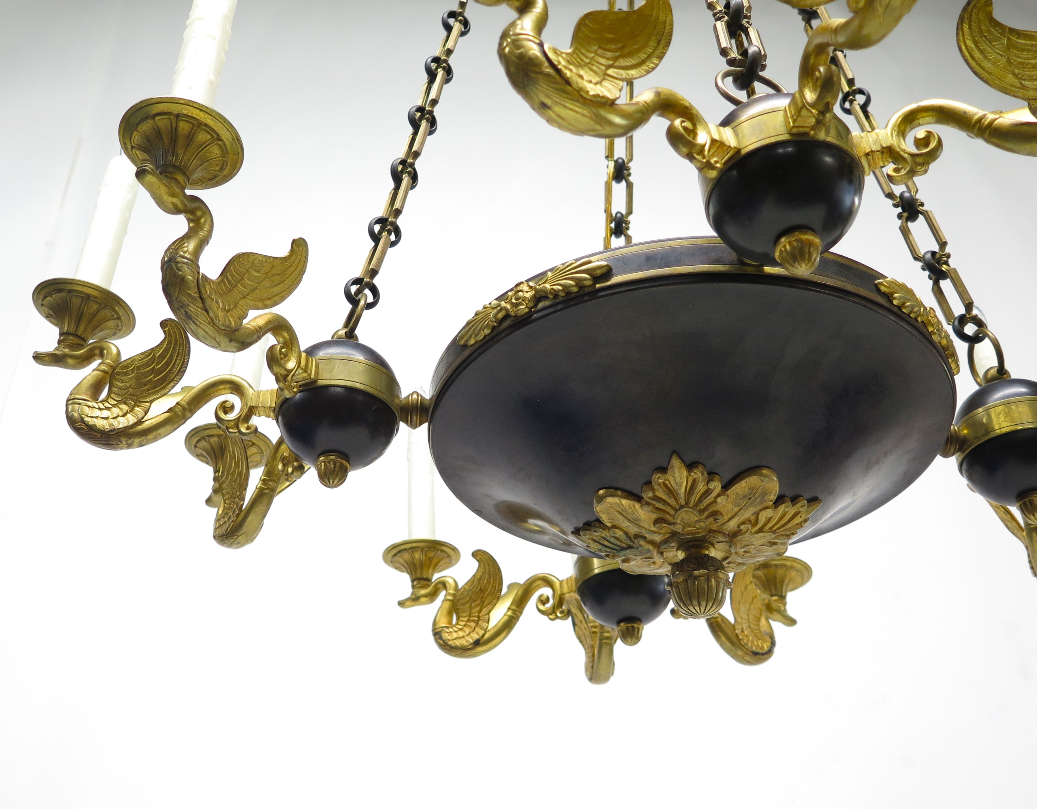 A Charles X Patinated and Gilt Metal Twelve Light Chandelier