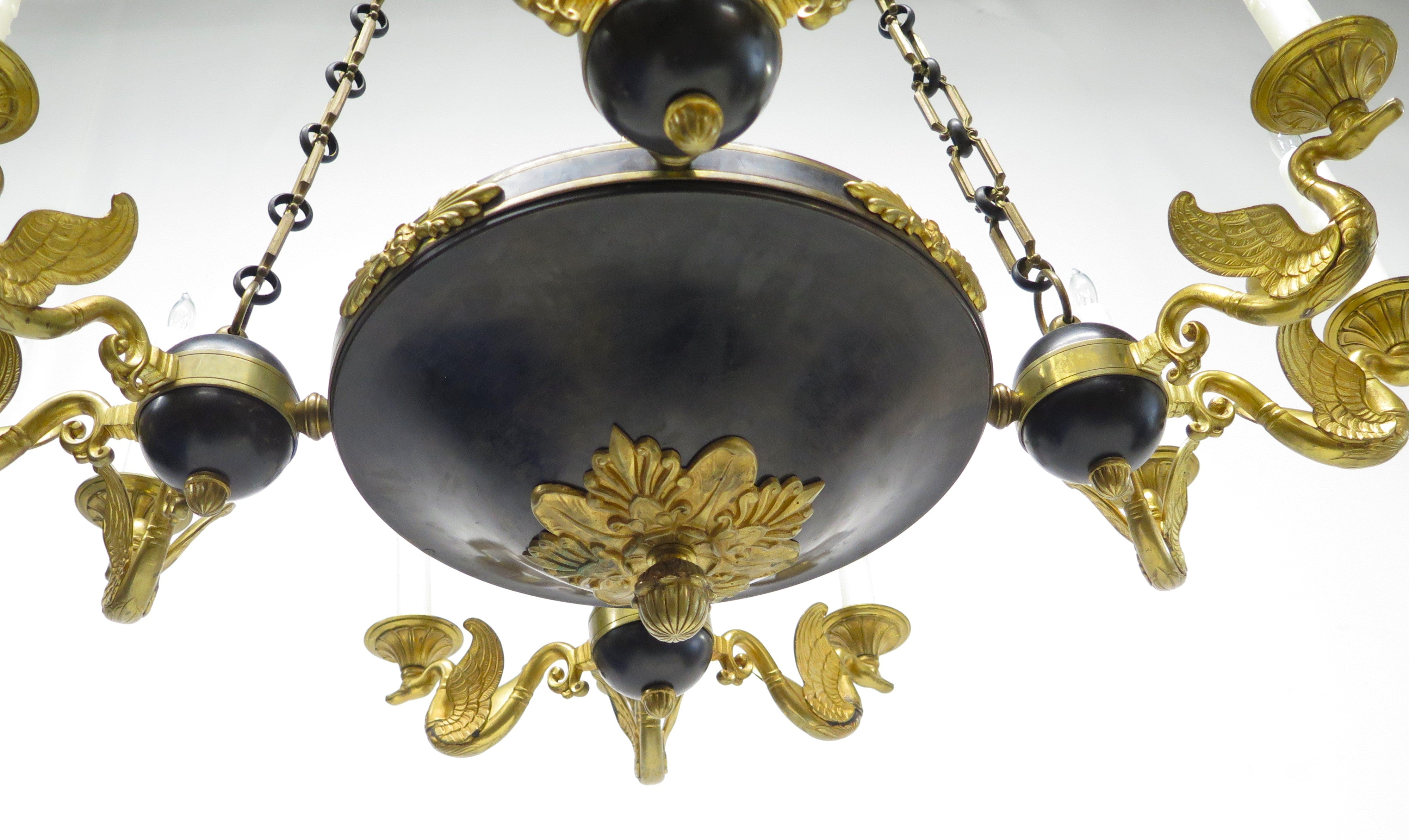 A Charles X Patinated and Gilt Metal Twelve Light Chandelier