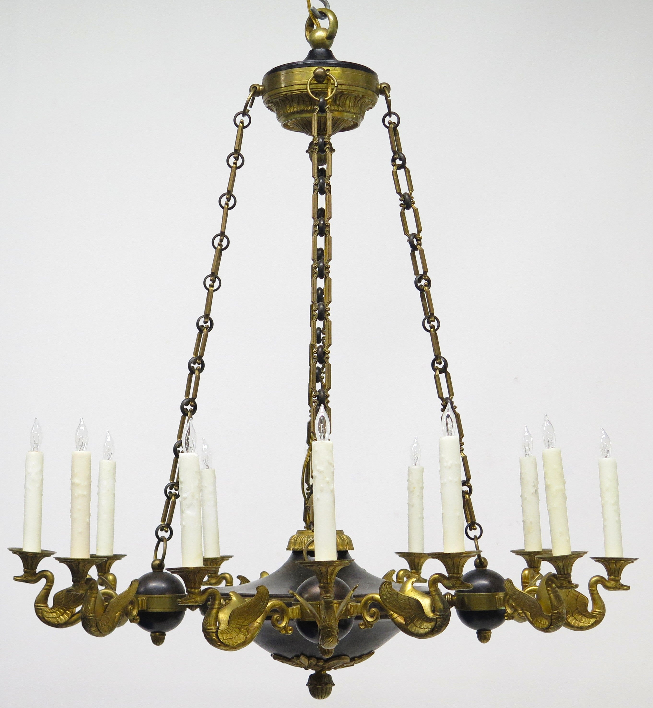 A Charles X Patinated and Gilt Metal Twelve Light Chandelier