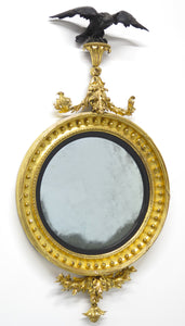 A Superb Early Regency Ebonised and Giltwood Convex Mirror