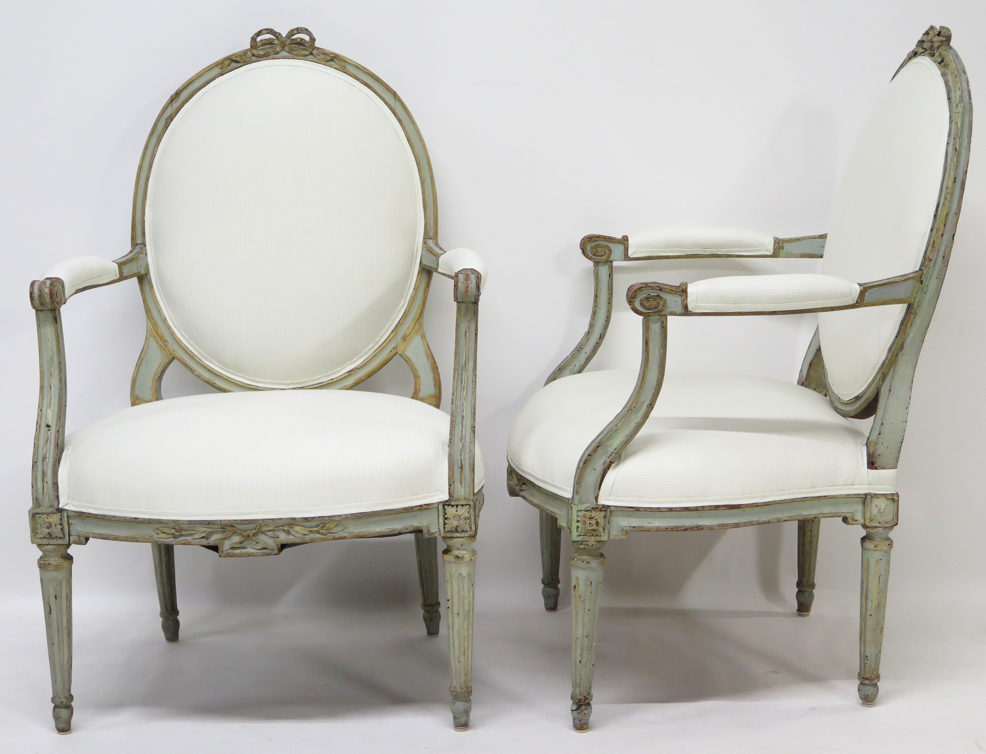 A Pair of 18th Century Paint and Parcel Gilt Italian Arm Chairs