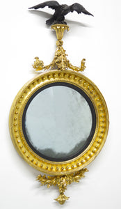 A Superb Early Regency Ebonised and Giltwood Convex Mirror