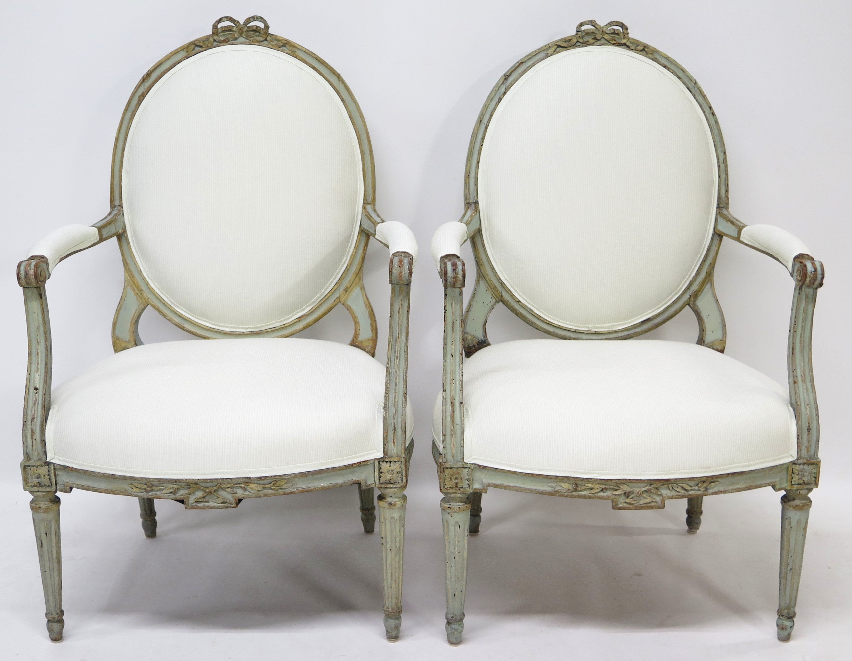 A Pair of 18th Century Paint and Parcel Gilt Italian Arm Chairs