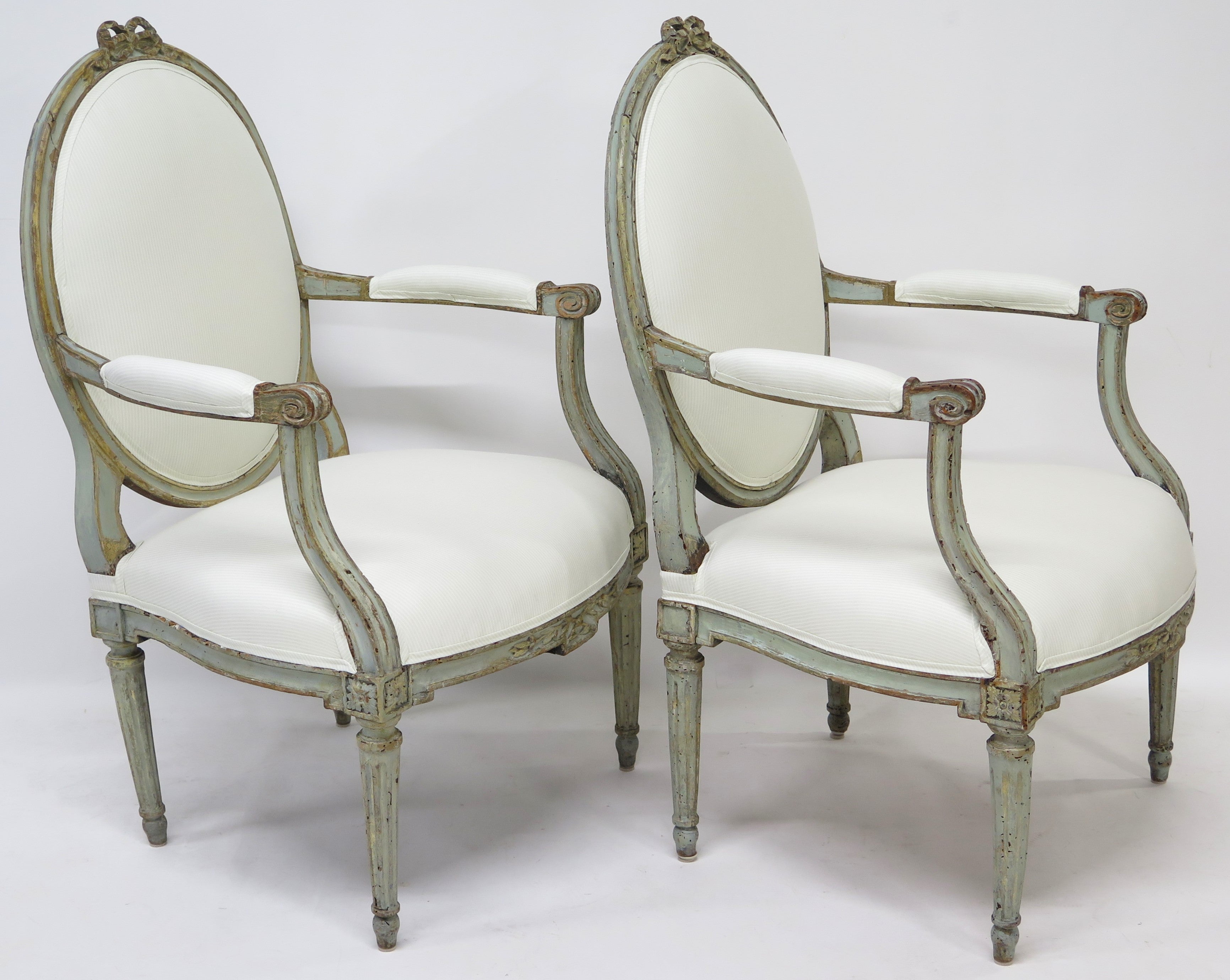 A Pair of 18th Century Paint and Parcel Gilt Italian Arm Chairs