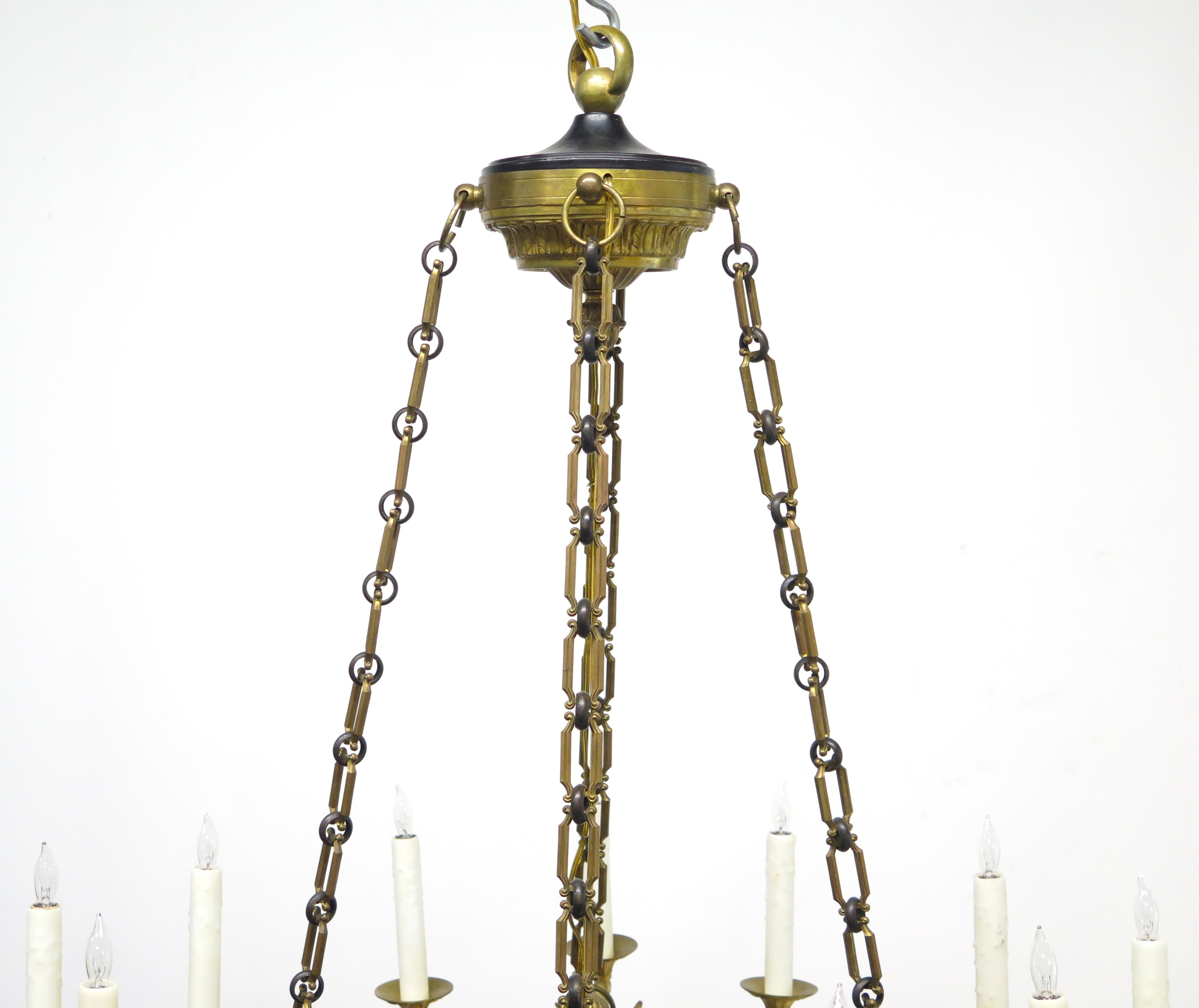 A Charles X Patinated and Gilt Metal Twelve Light Chandelier