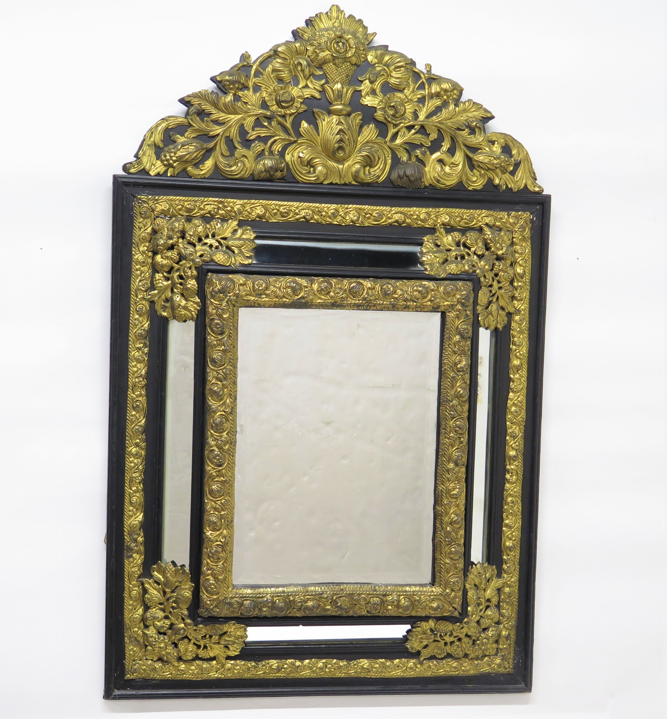 Dutch Looking Glass of Ebony and Brass Repoussé