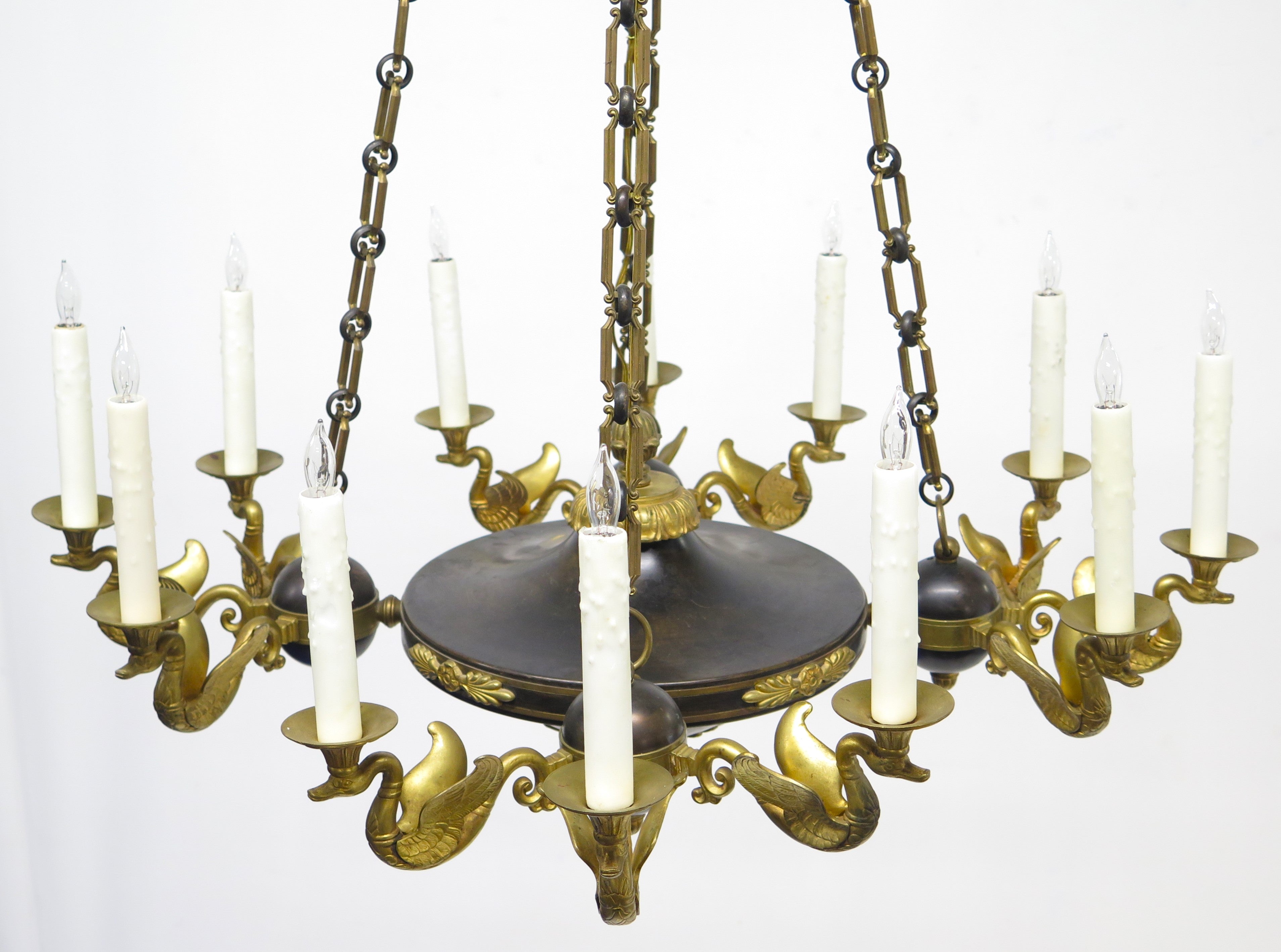 A Charles X Patinated and Gilt Metal Twelve Light Chandelier