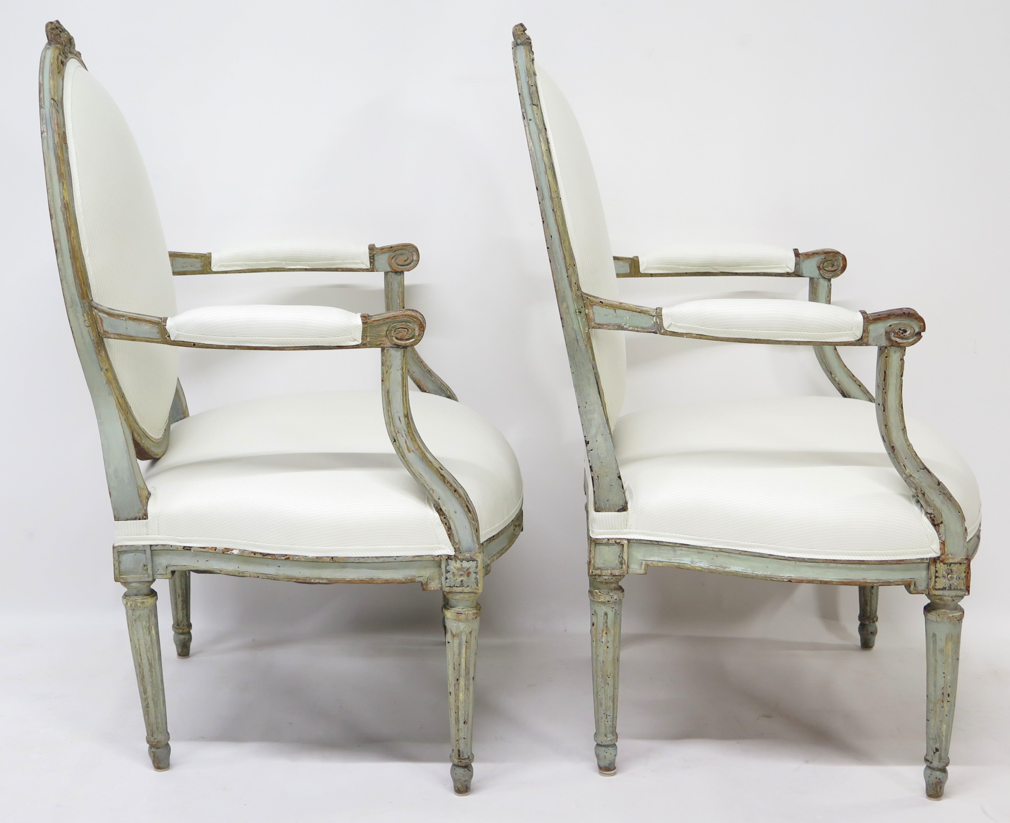 A Pair of 18th Century Paint and Parcel Gilt Italian Arm Chairs