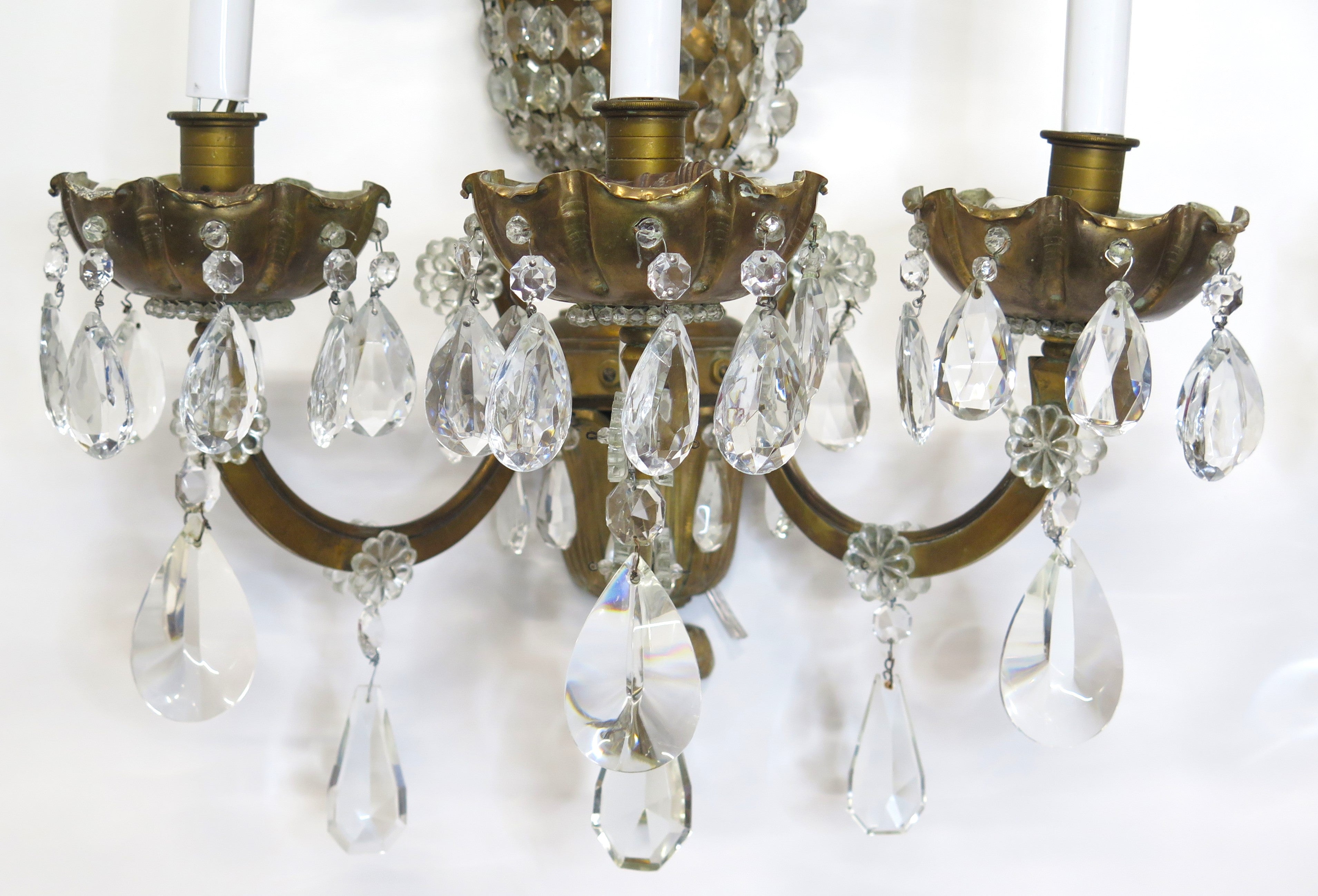 A Pair of Maison Jansen Three Light Bronze and Crystal Sconces