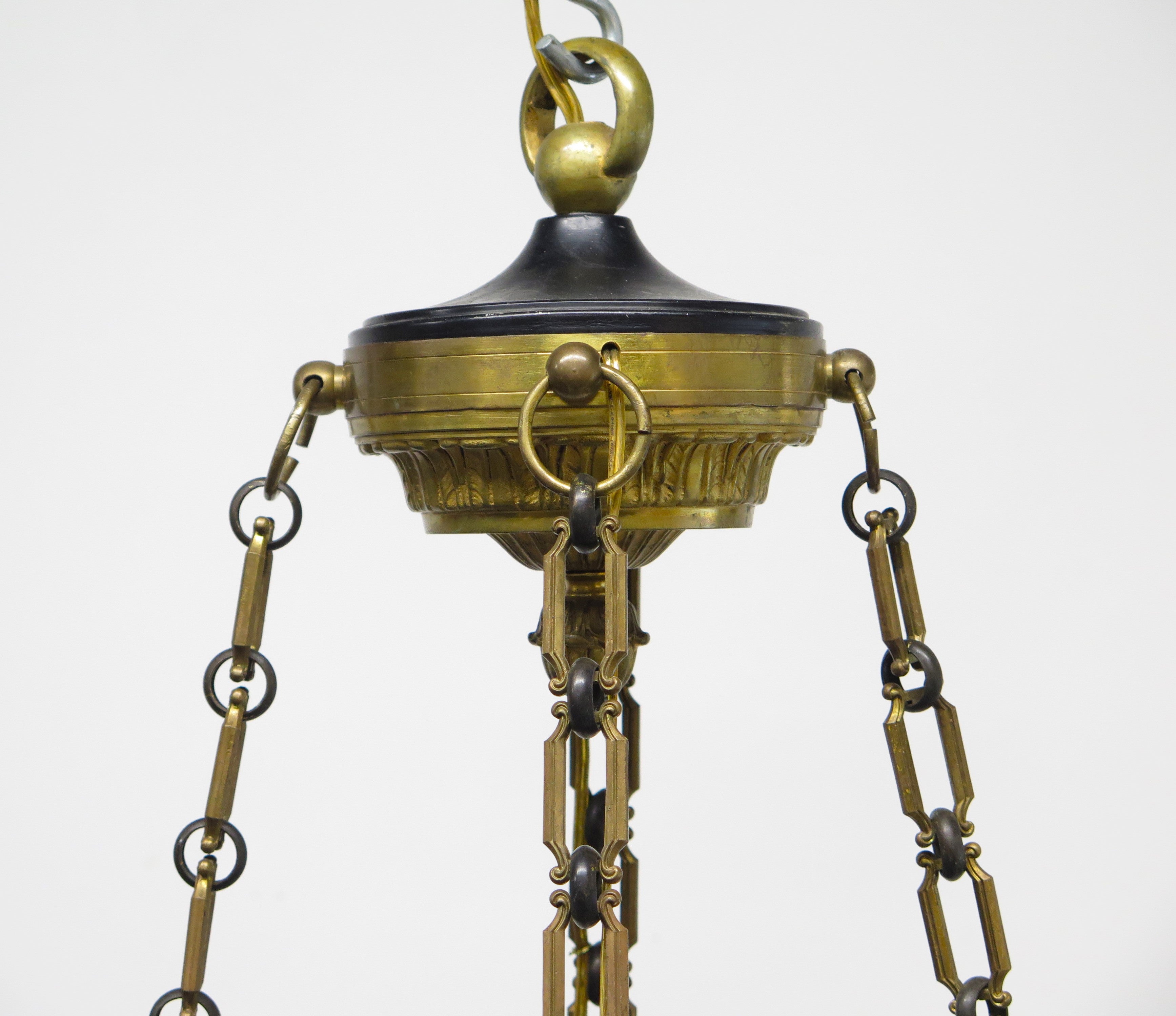 A Charles X Patinated and Gilt Metal Twelve Light Chandelier