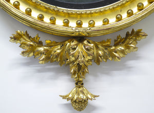 A Superb Early Regency Ebonised and Giltwood Convex Mirror