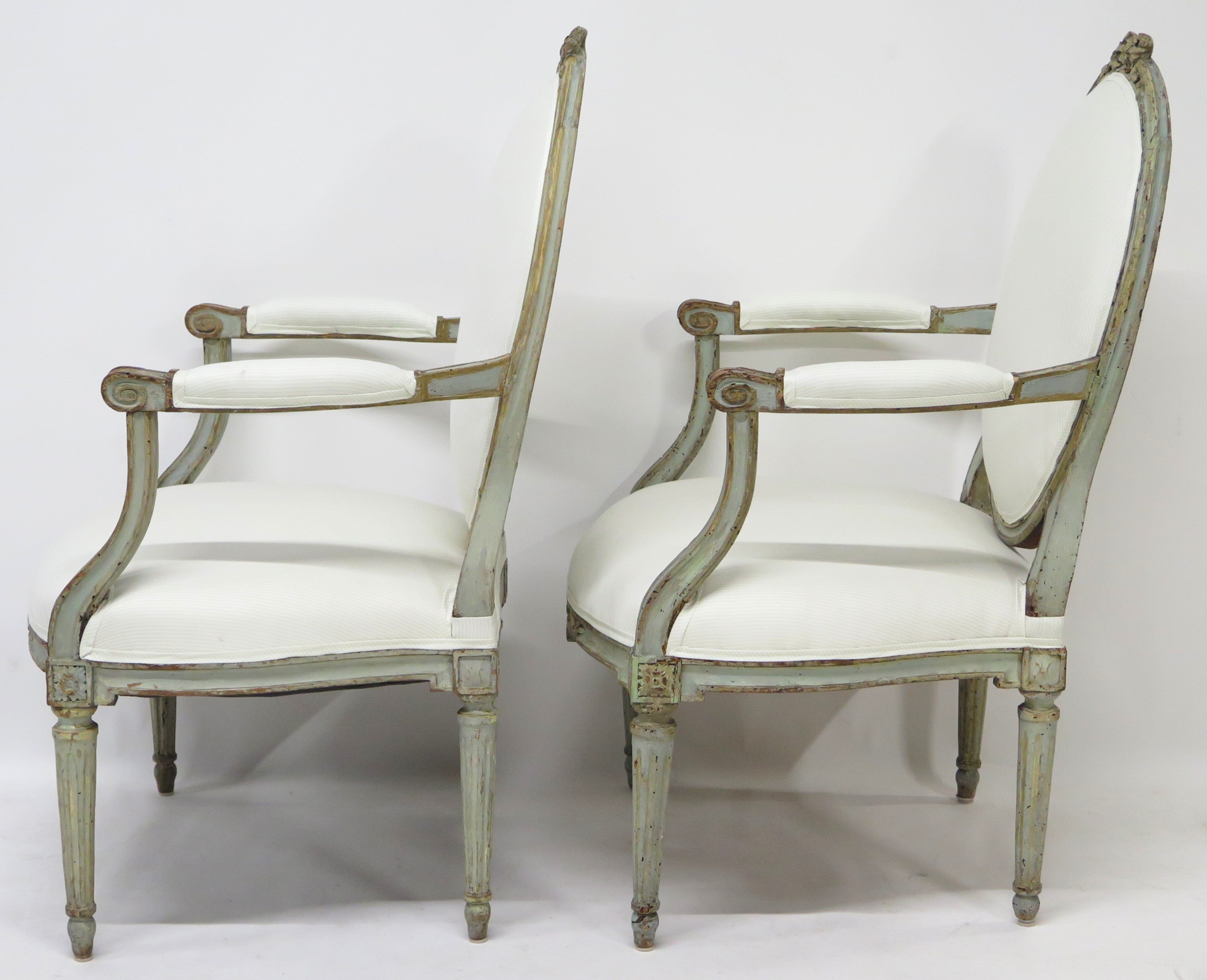 A Pair of 18th Century Paint and Parcel Gilt Italian Arm Chairs