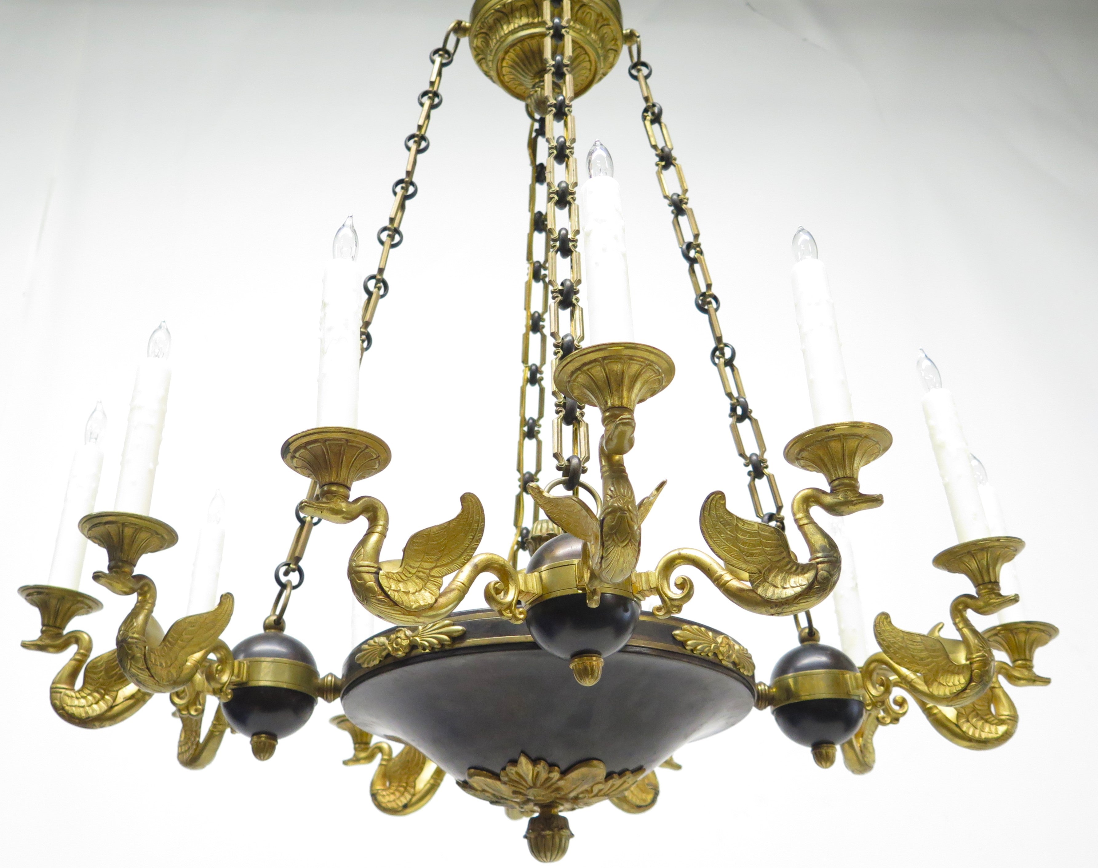 A Charles X Patinated and Gilt Metal Twelve Light Chandelier