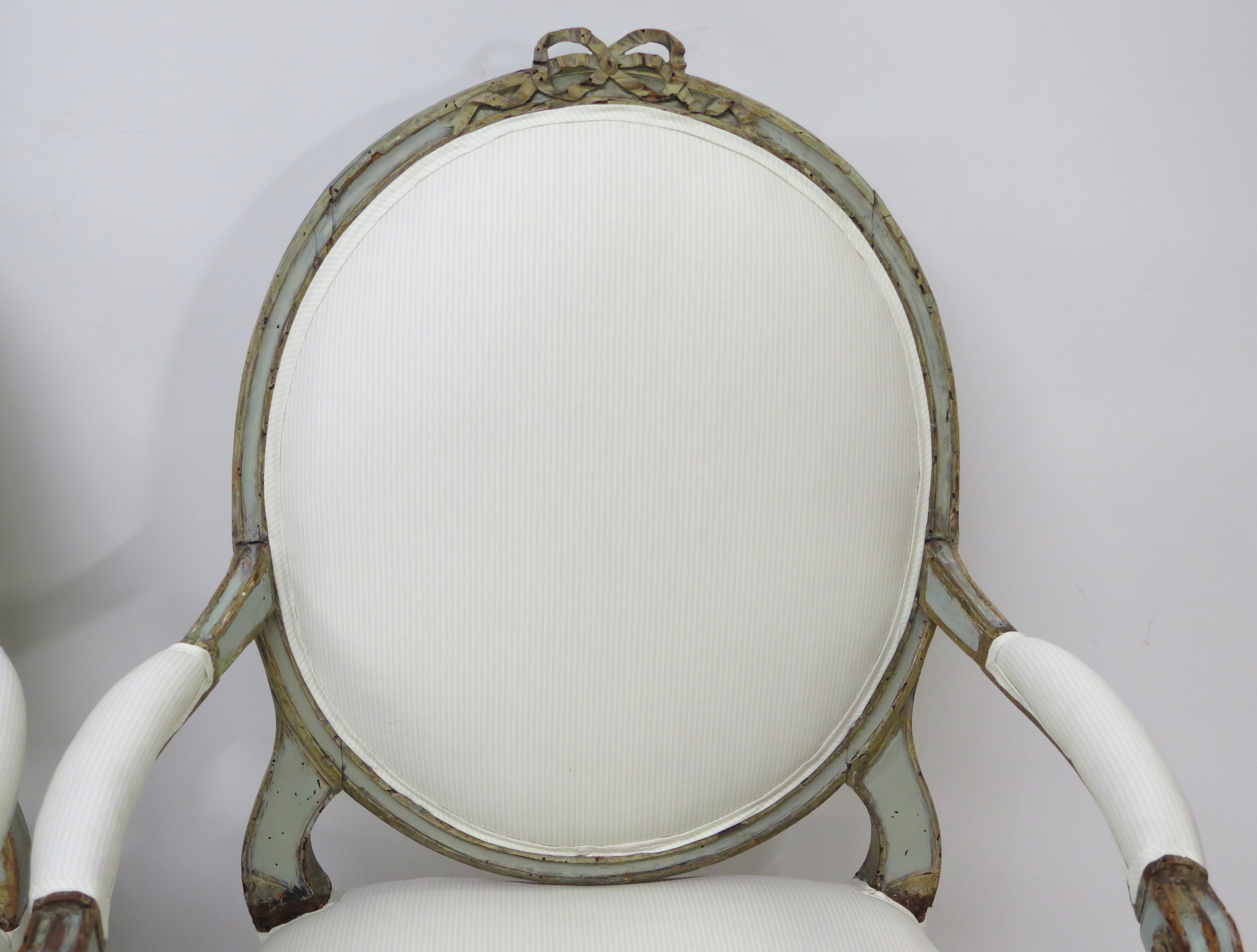 A Pair of 18th Century Paint and Parcel Gilt Italian Arm Chairs