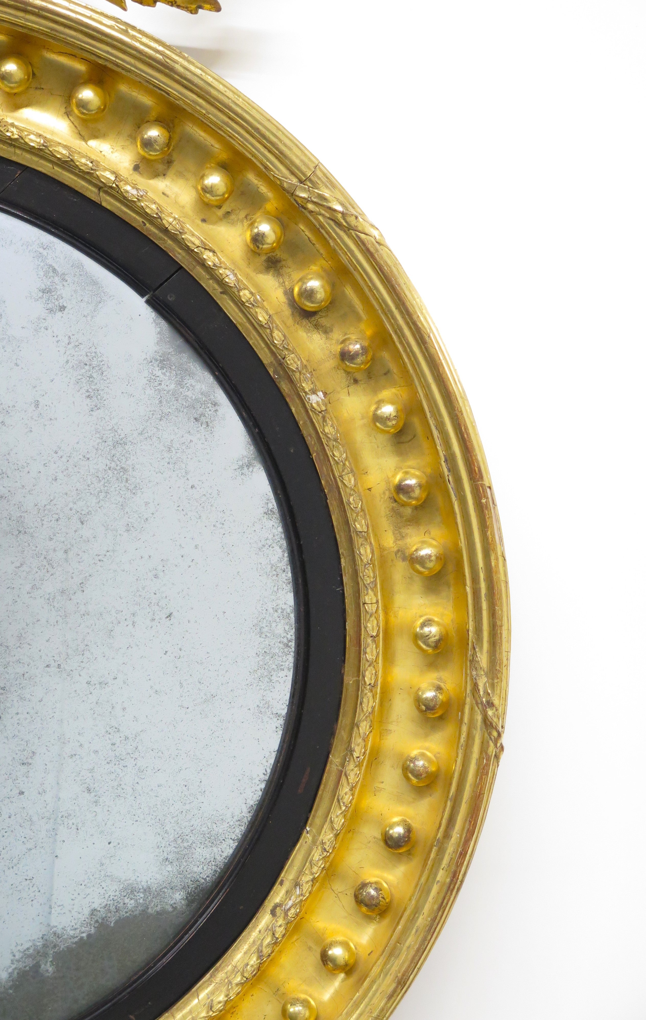 A Superb Early Regency Ebonised and Giltwood Convex Mirror