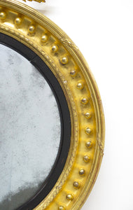 A Superb Early Regency Ebonised and Giltwood Convex Mirror