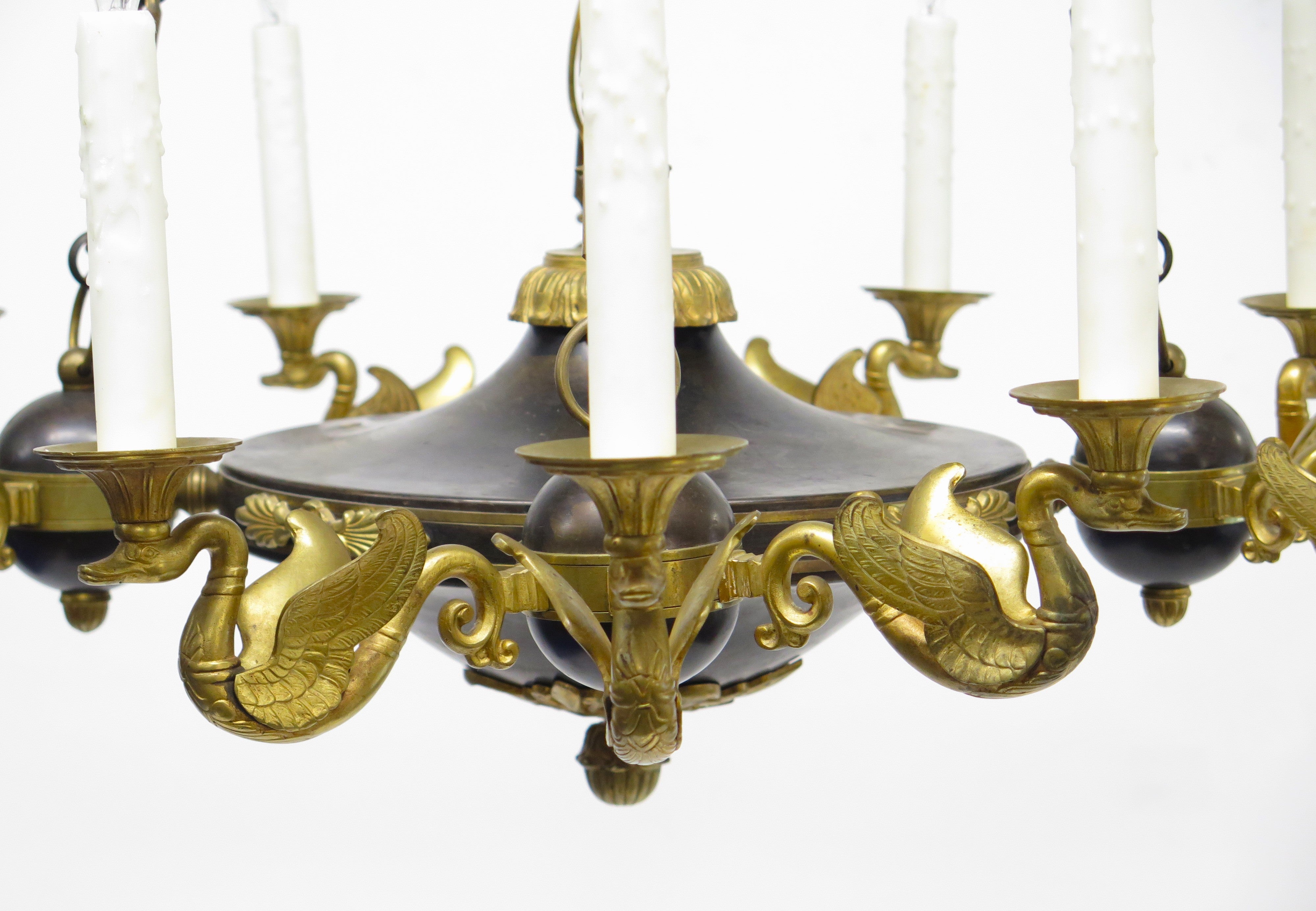 A Charles X Patinated and Gilt Metal Twelve Light Chandelier