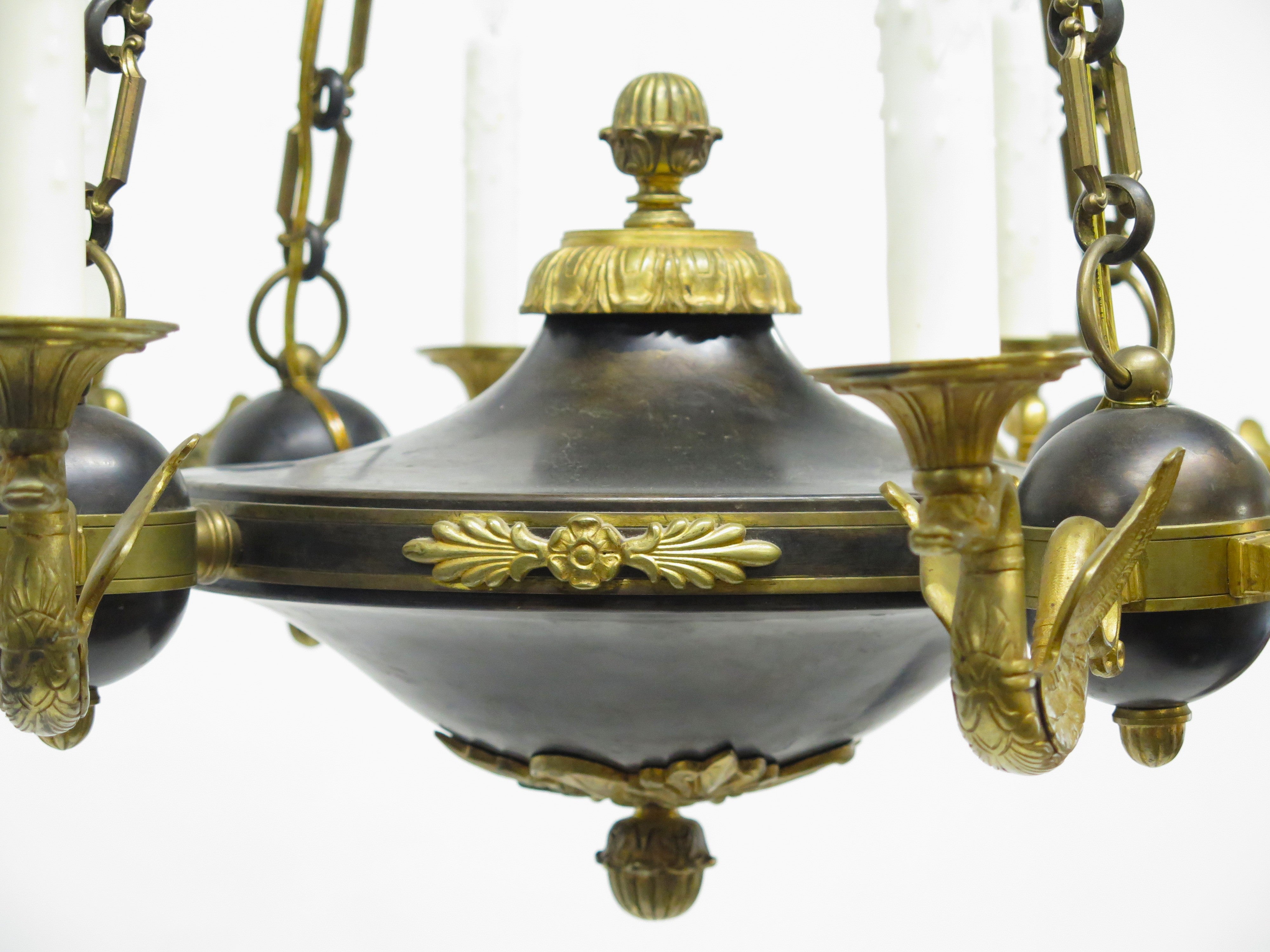 A Charles X Patinated and Gilt Metal Twelve Light Chandelier