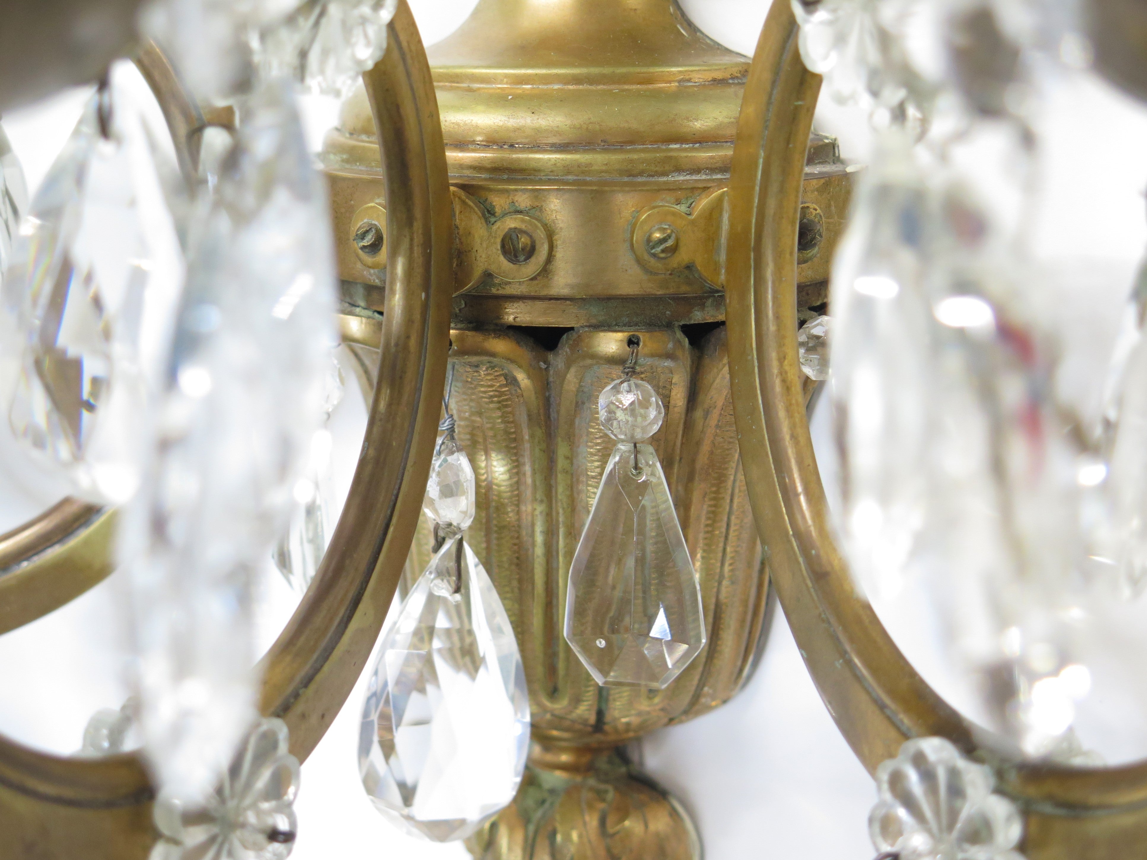 A Pair of Maison Jansen Three Light Bronze and Crystal Sconces