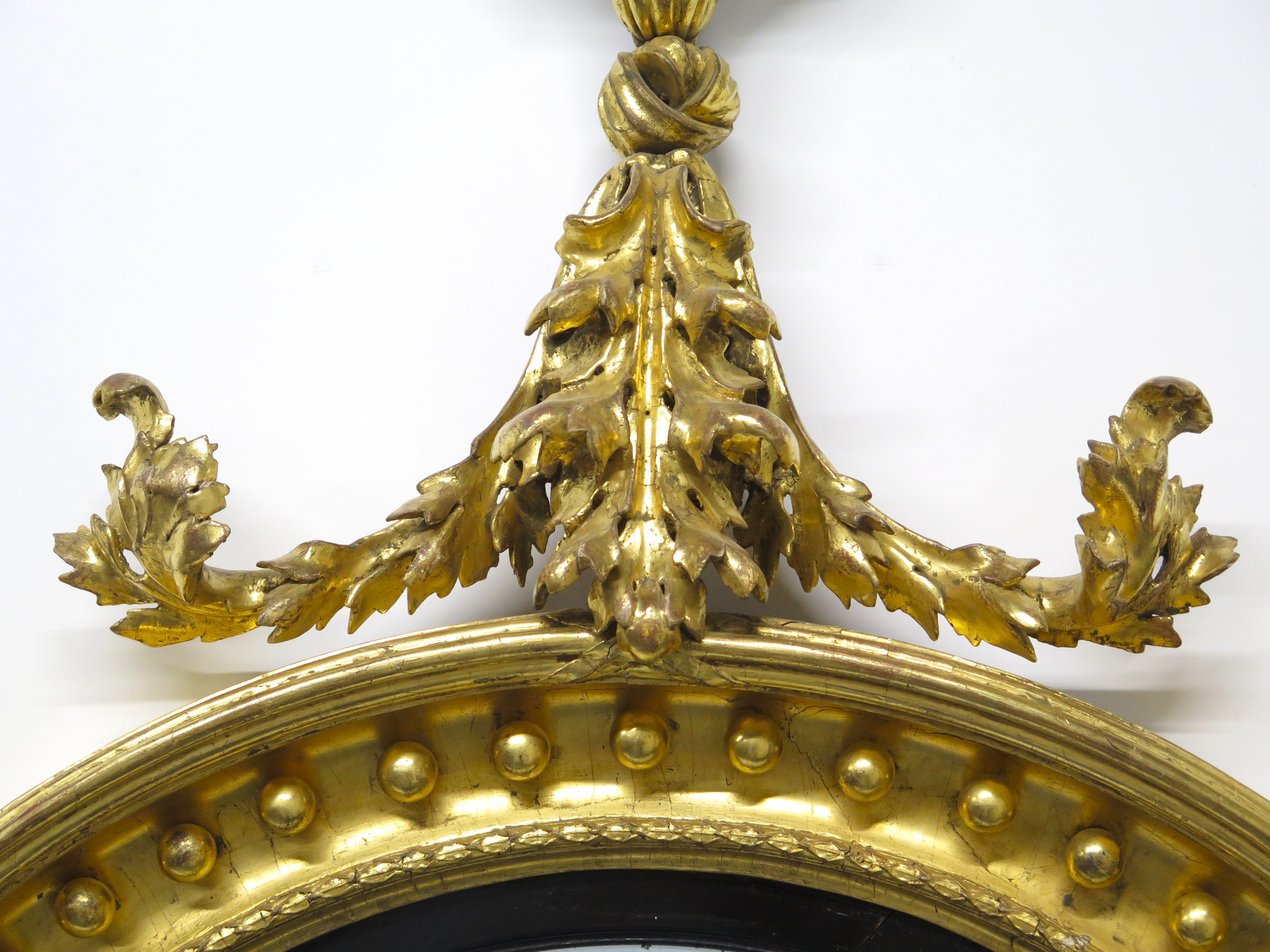 A Superb Early Regency Ebonised and Giltwood Convex Mirror