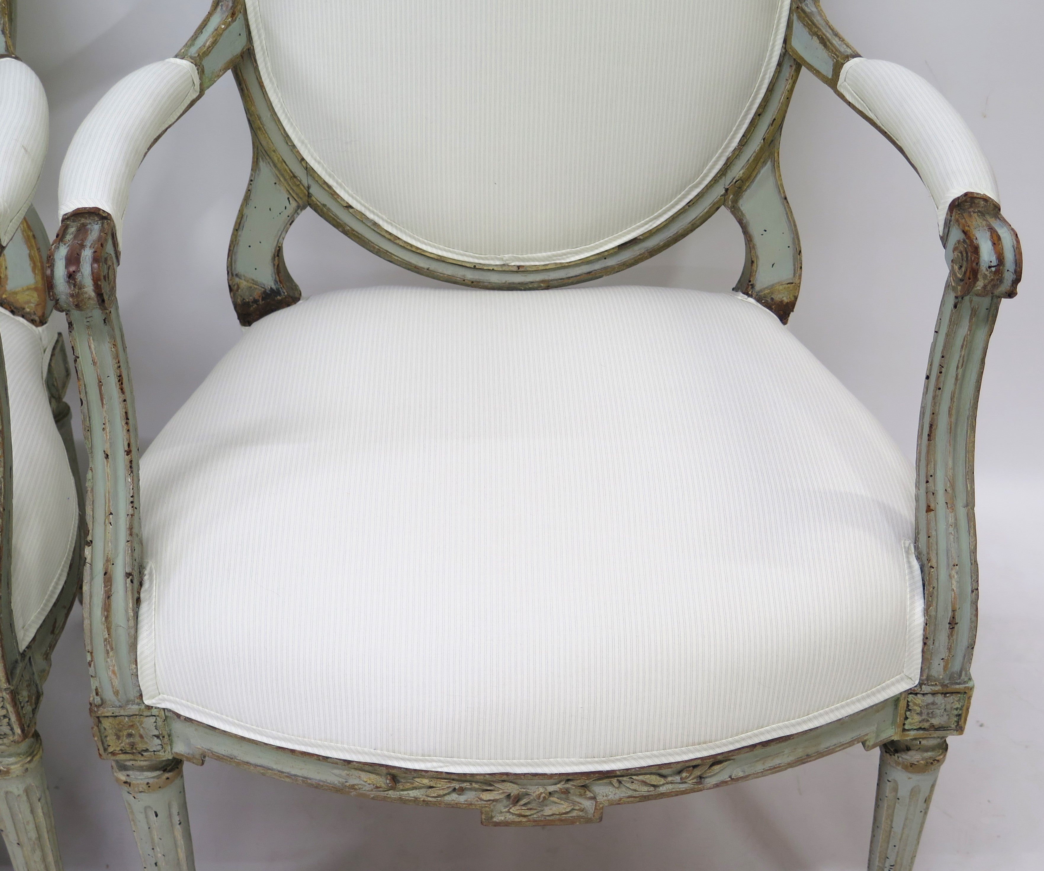 A Pair of 18th Century Paint and Parcel Gilt Italian Arm Chairs