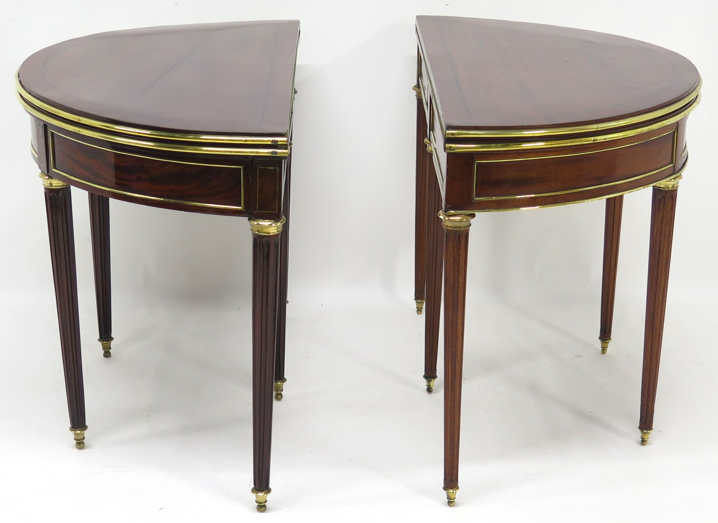 A Beatiful "Near" Pair of Louis XVI Style Mahogany and Brass Mounted Demilune Games Tables
