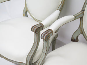 A Pair of 18th Century Paint and Parcel Gilt Italian Arm Chairs