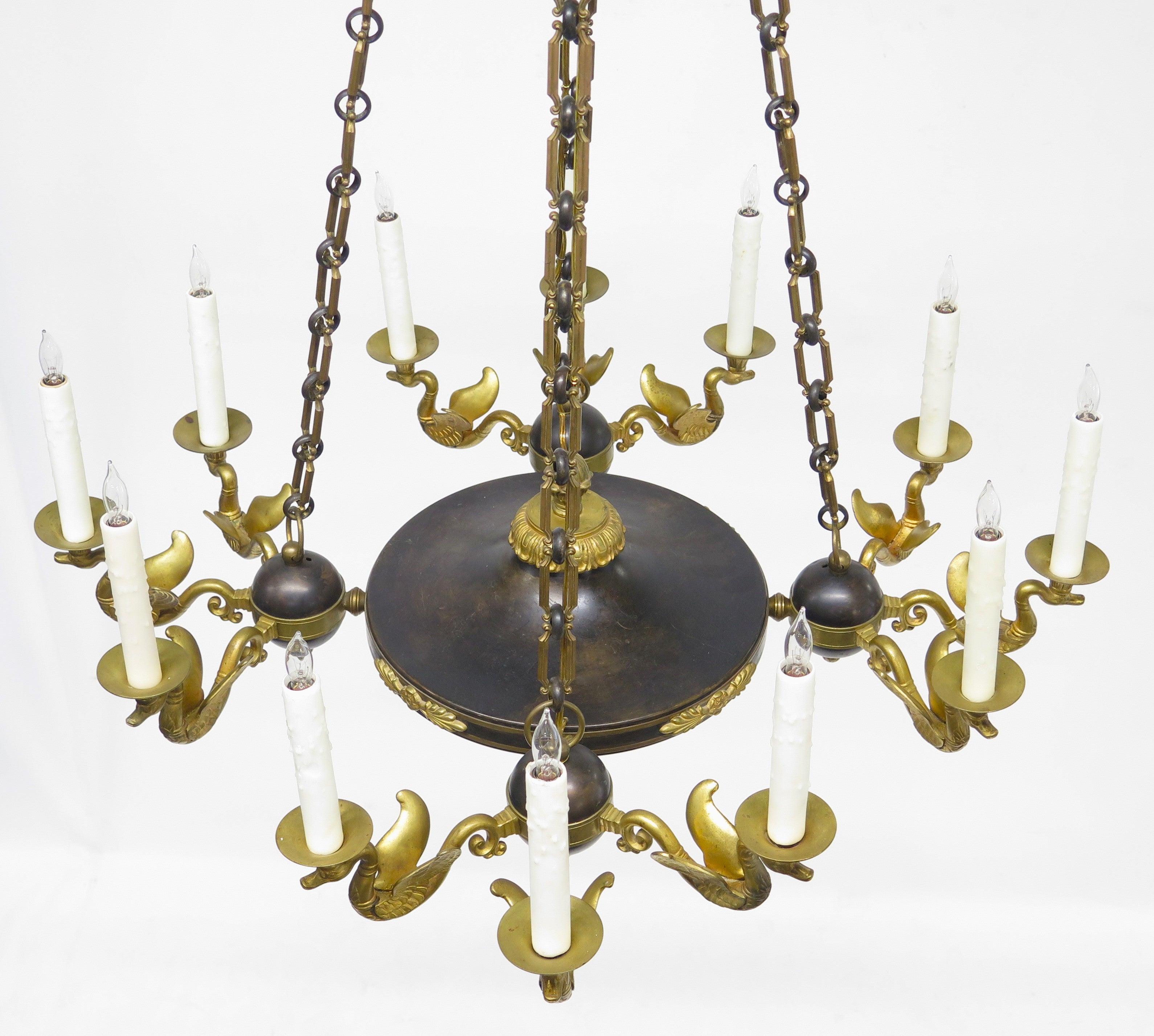 A Charles X Patinated and Gilt Metal Twelve Light Chandelier