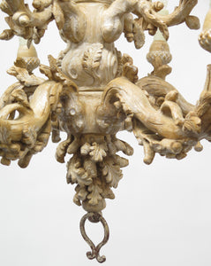 A Carved Italian Faux Bois Pickled Ten Light Chandelier
