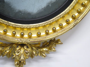 A Superb Early Regency Ebonised and Giltwood Convex Mirror