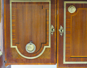 A French Ormolu-mounted Amaranth, Kingwood, Bois Satine, and Burr-amboyna Commode