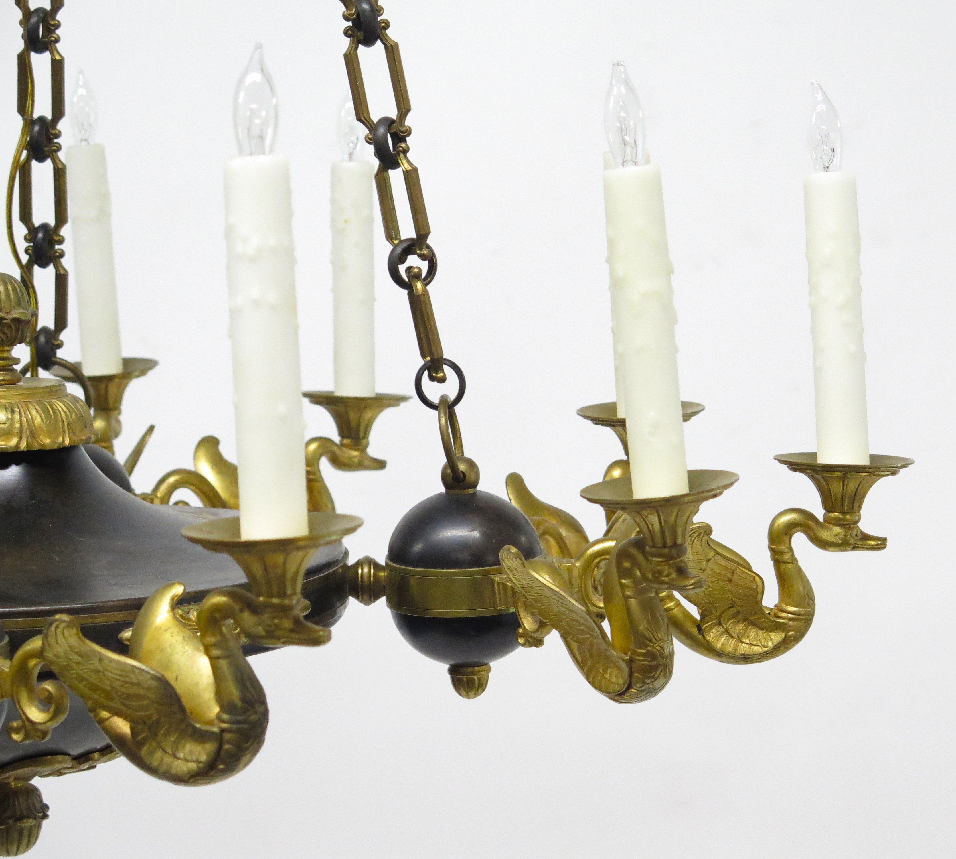 A Charles X Patinated and Gilt Metal Twelve Light Chandelier