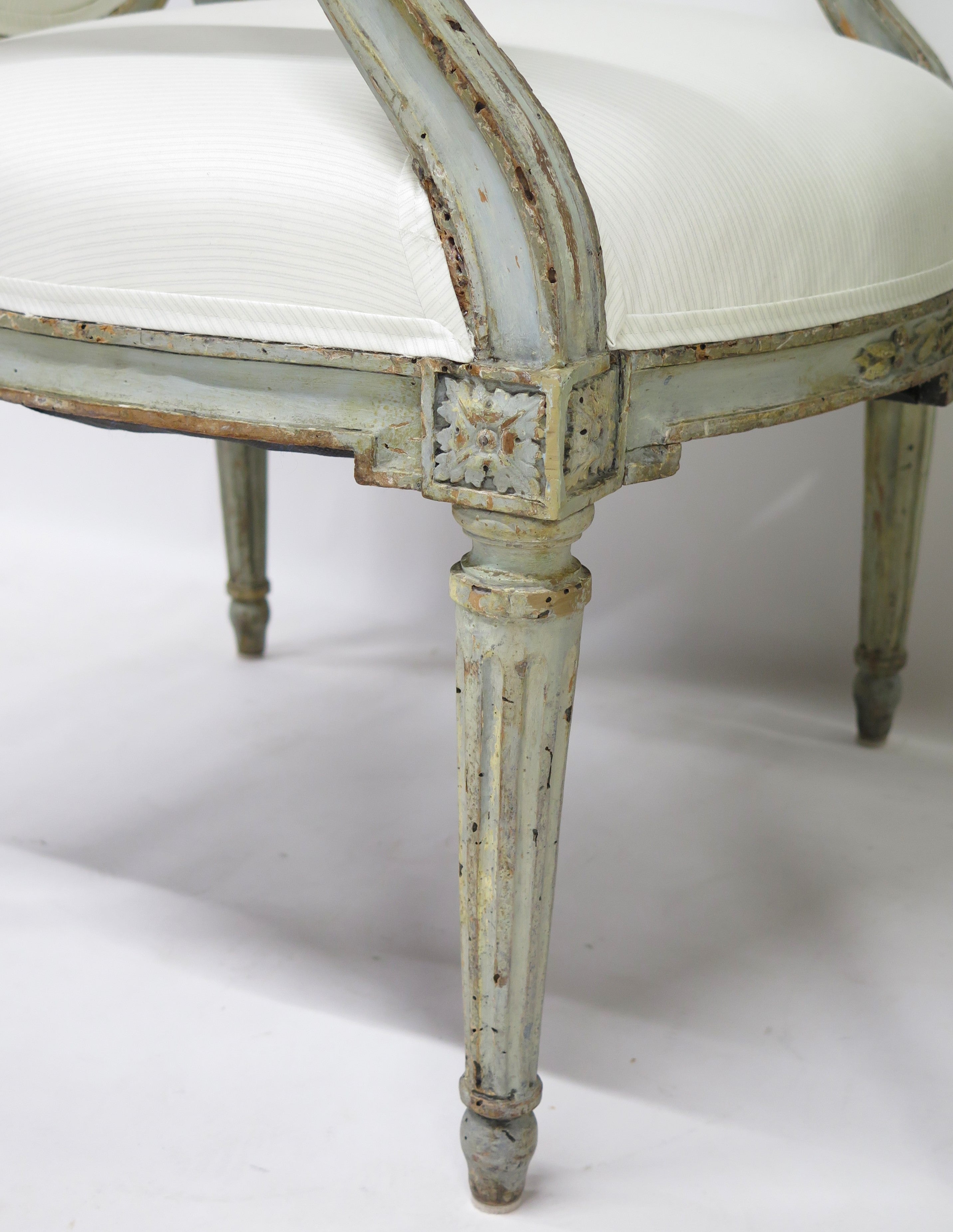 A Pair of 18th Century Paint and Parcel Gilt Italian Arm Chairs