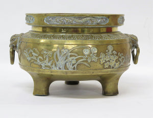 A Large Brass Container with Three Feet