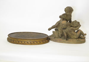 Terracotta Putti Statue Resting on Conforming Raised oval Base Signed " R. Rod "