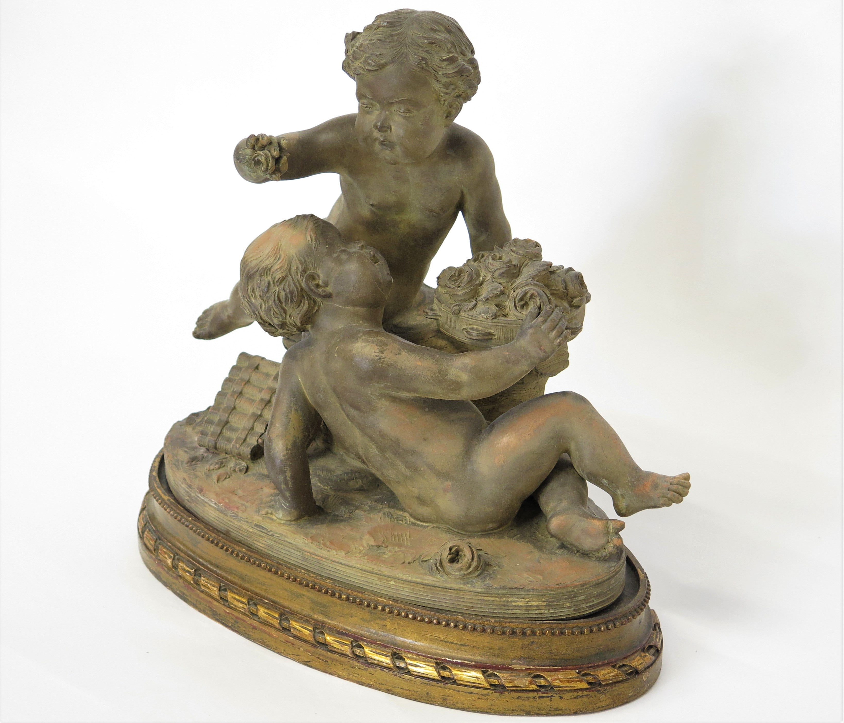 Terracotta Putti Statue Resting on Conforming Raised oval Base Signed " R. Rod "