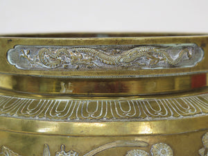 A Large Brass Container with Three Feet