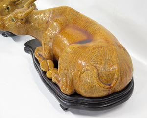 Chinese Ochre Glazed Recumbent Oxen on Carved Wooden Stands