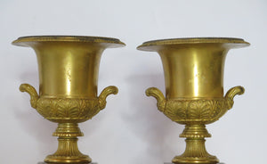 A Pair of Grand Tour Gilt Bronze Campagna Urns on Rouge Griotte Marble Plinths