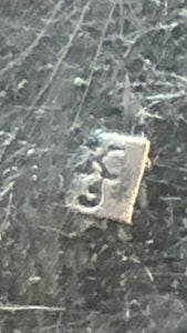 close up of silversmith's mark, K over the number 3?